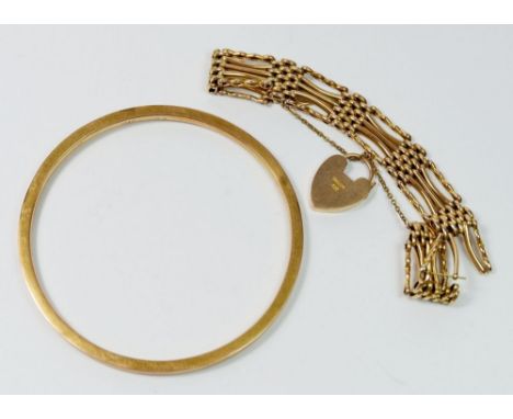 A 9 carat gold bangle, 8.2cm diameter, 6.5g and a 9 carat gold gate link bracelet, 15.6g 