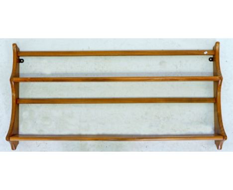 An Ercol light elm plate rack 