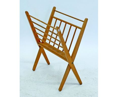 An Ercol light wood folding magazine rack 