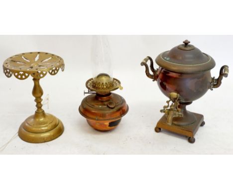 A copper samovar, a brass trivet and a copper oil lamp