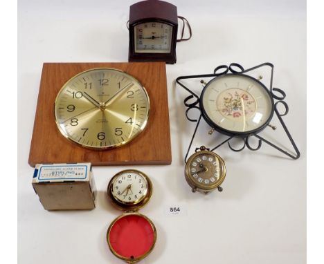 A collection of five clocks including a Junghans astra quartz, a Smiths sectric bakelite clock, a Stirling travelling alarm c