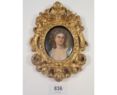 A miniature portrait painted on oval porcelain plaque of a woman, marked to verso Potoroka, Firenze, in ornate gilt frame
