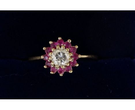 A 9 carat gold ruby and diamond cluster ring, centre stone approx 1/4 carat, 1.8g, size J 