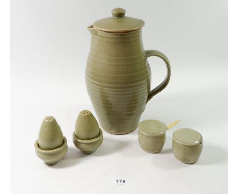 A Leach Pottery green glazed covered jug and a six piece cruet set 