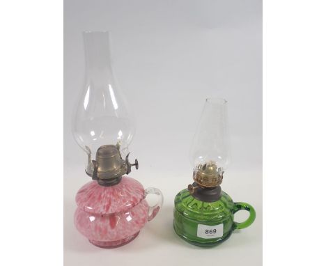 A Victorian mottled pink glass finger lamp and a green glass one 