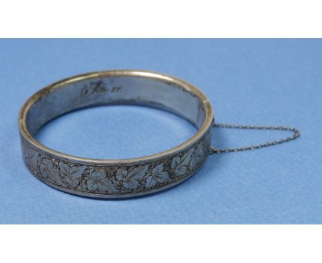 A Victorian silver bangle engraved leaves and dated Feb 1889, 20g 