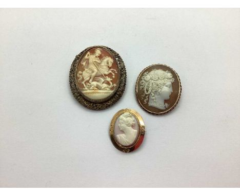 George and The Dragon Oval Shell Carved Cameo Brooch, within scroll pierced frame, stamped "800"; a smaller oval shell carved