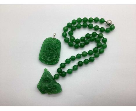 A Modern Green Jade Bead Necklace, to magnetic clasp, suspending dragon design panel pendant; together with a further panel p