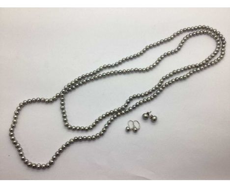Flapper Length Freshwater Pearl Bead Necklace, together with a pair of button pearl earrings, to hinge topped backs, stamped 