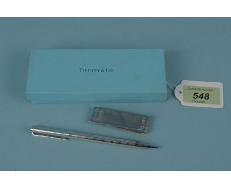 A silver money clip marked Tiffany &amp; Co together with a silver pen marked Tiffany &amp; Co