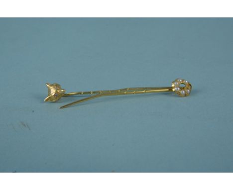 A yellow metal fox head stick pin with diamond set eyes together with an 18ct gold seed pearl set stick pin (one pearl missin