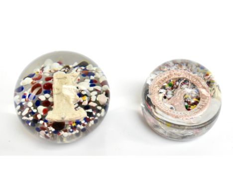 Two early 20th century end of day glass paperweights to include a WWI example encased with South African infantry brigade emb