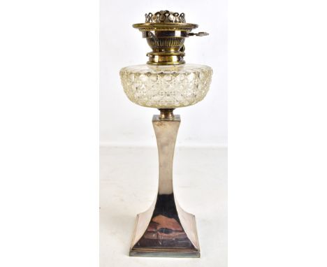 An Art Deco silver plated oil lamp with cut clear glass reservoir and swept base, stamped HE &amp; Co, height 44cm.Additional