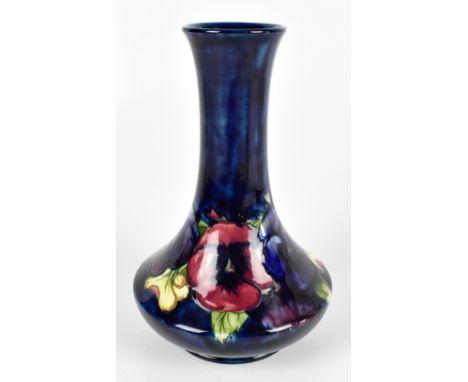 WILLIAM MOORCROFT; a baluster vase with cylindrical neck decorated in the Pansy pattern on a blue ground, blue signature and 