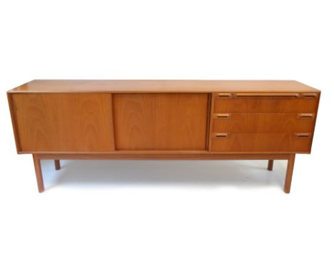 A. H. McINTOSH &amp; CO LTD; a mid-century teak sideboard, with two sliding doors flanked on one side by slide and three draw