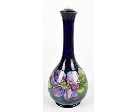 WALTER MOORCROFT; a table lamp of baluster form in the Clematis pattern, blue signature and original paper label to base, hei