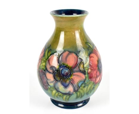 WALTER MOORCROFT; a baluster vase decorated in the Anemone pattern with flambé flowers on a green/blue ground, blue signature