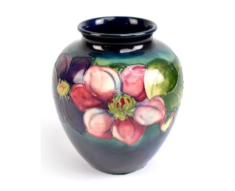 WALTER MOORCROFT; a bulbous vase decorated in the Clematis pattern on a green and blue ground, impressed marks and signature 