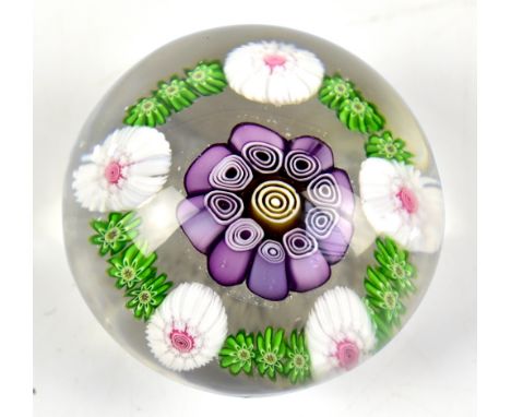 CLICHY; a clear glass paperweight with central Clichy rose cane, diameter 4.2cm.&nbsp;Additional InformationLight wear, small