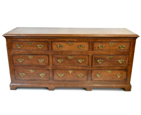 A late George III oak and pollard oak crossbanded nine drawer dresser base with moulded three plank top and moulded bracket b