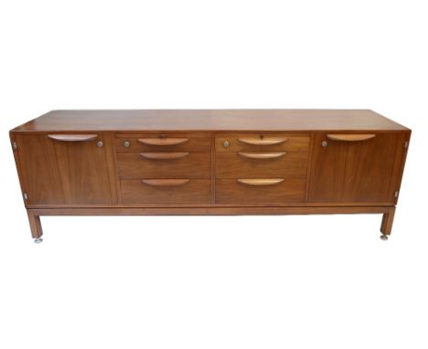 JENS RISOM DESIGN LTD; a mid-century American walnut sideboard, with an arrangement of six central drawers flanked by two cup