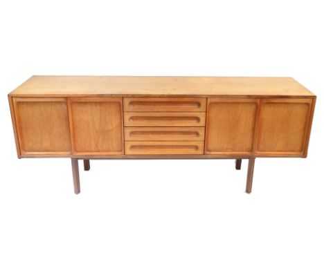 MEREDEW; a mid-century teak sideboard with an arrangement of four drawers flanked by four panelled cupboard doors, raised on 