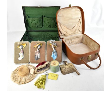 A vintage leather case embossed with initials 'L.A.', width 40cm, containing a doll's hat, two modern ceramic plaques, etc, a