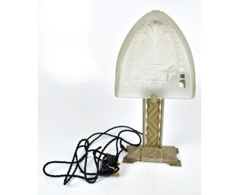 A reproduction Art Deco style table lamp with frosted glass shade and impressed chevron and floral decoration, raised on a po