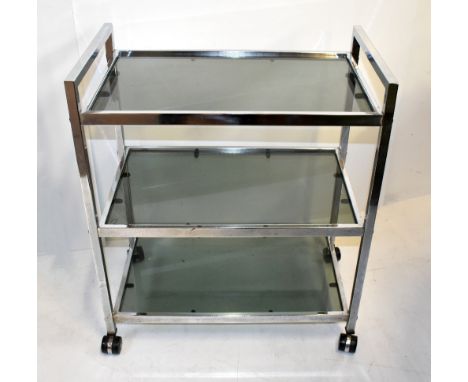 A chromed and smoked glass three tiered tea trolley, width 61cm, height 71cm, depth 37cm.Additional InformationSome pitting t