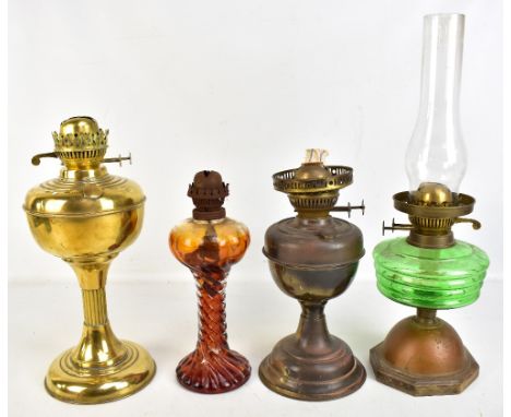 Four vintage oil lamps, one with green glass reservoir, one all brass and one with amber tinted glass reservoir and body, hei