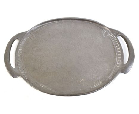 ENGLISH PEWTER; an Arts &amp; Crafts pewter twin handled tray with planished decoration to the centre within stylised embosse