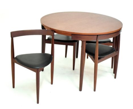 HANS OLSEN FOR FREM ROJLE; an extending teak dining table, diameter unextended 105.5cm, and a set of four original chairs wit