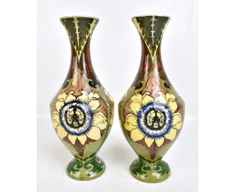 A pair of Dutch faience vases decorated with abstract floral sprays, painted marks to base, height 27cm (one af).Additional I