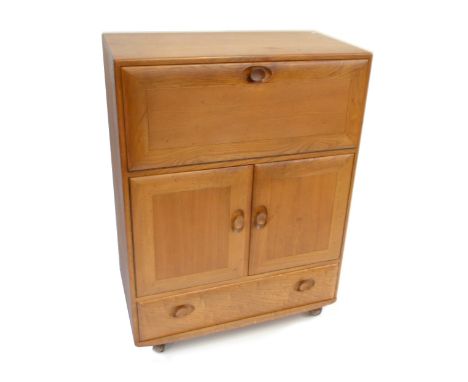 ERCOL; a light elm Windsor drinks cabinet with pull down door above two panelled cupboard doors and single base drawer, heigh