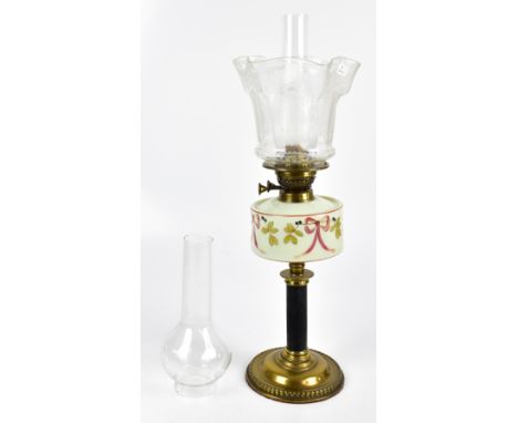 An Edwardian brass oil lamp with painted opaque glass reservoir and etched glass shade, with two glass chimneys, height inclu