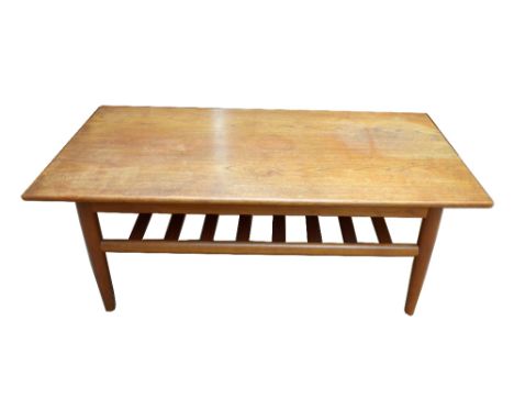 A Danish teak mid-century rectangular coffee table with under tier magazine shelf and impressed indistinct marks to the under