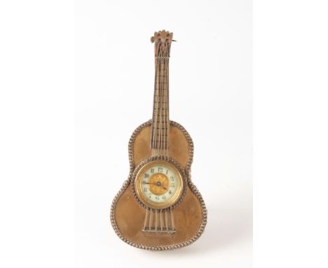 A LATE 19TH CENTURY FRENCH STRUNG MUSICAL INSTRUMENT NOVELTY MANTEL CLOCK modelled as a guitar fronted in brass with silvered