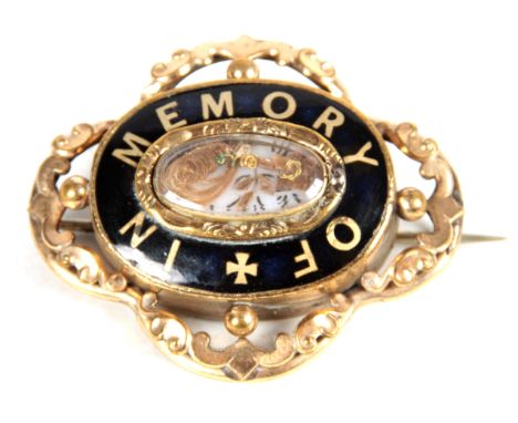 A VICTORIAN MOURNING BROOCHwith ornate gilt case with black enamel border with the message reading "IN MEMORY OF" the centre 