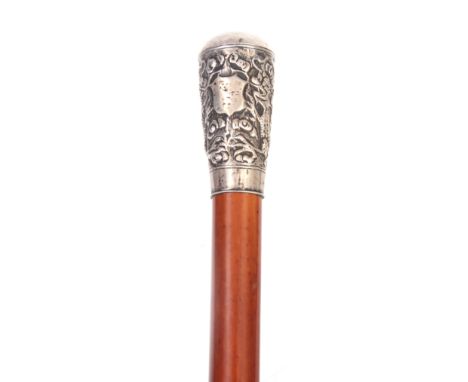 A 19TH CENTURY MALACCA AND SILVER MOUNTED WALKING STICK decorated with dragon and floral work pommel 93cm overall