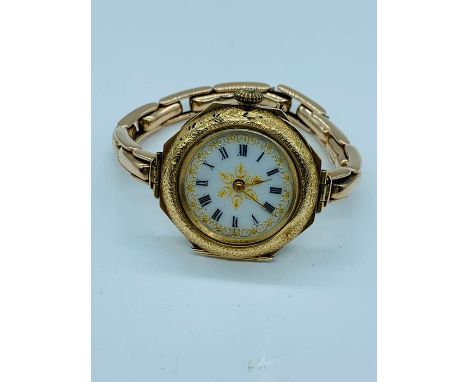 A Ladies decorative enamel watch with enamel face and 9ct gold strap.