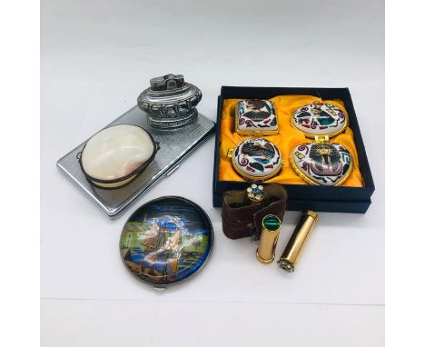 A selection of pill boxes to include four Egyptian themed ones in original box, a white metal and enamel one with painted shi