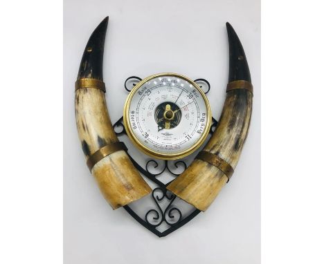 A swiss style barometer with horn detail