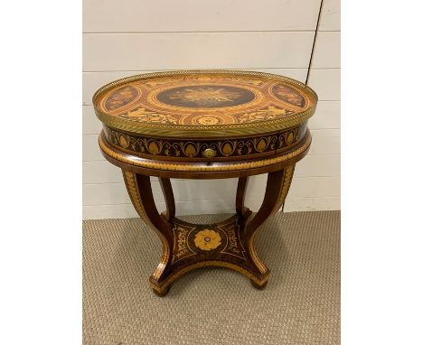 A small centre table with marquetry to top, legs and shelf under, with brass banded around table top