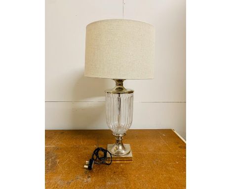 A contemporary glass and white metal table lamp