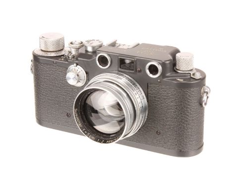 A Leica IIIc Rangefinder Camera, 1942, grey, serial no. 387804, with Leitz Summitar f/2 50mm lens, 1941, chrome, serial no. 5