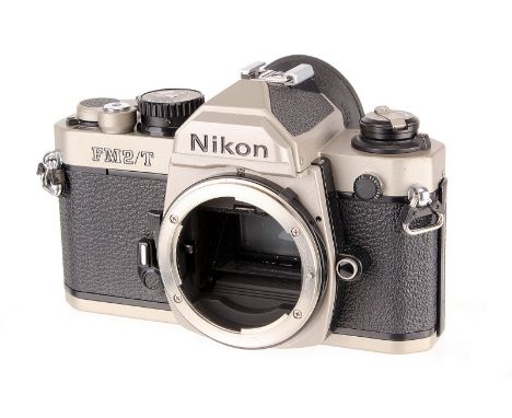 A Nikon FM2/T SLR Body, titanium, serial no. T9001783, body, G-VG, shutter fires but mirror locks up 