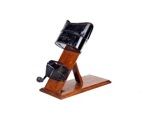 A Kinora Viewer, mounted on wooden-plinth, with manual hand crank drive, body, G, optics, slight chip to corner, together wit