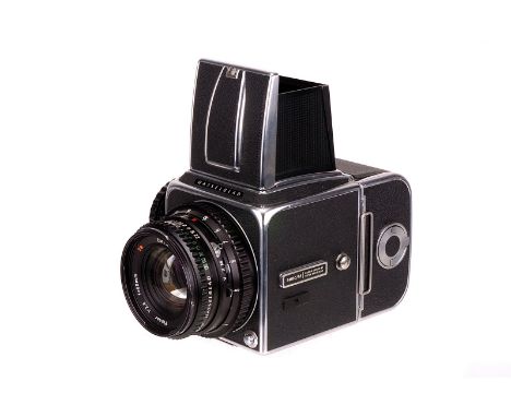 A Hasselblad 500C/M Camera, chrome, serial no. UE1232823, with Carl Zeiss Planar T* f/2.8 80mm lens, black, serial no. 619841