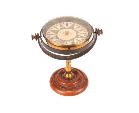 An early 20th Century lacquered and anodised brass Desk Gimbal Compass, with floating card dial, on turned mahogany base, 160