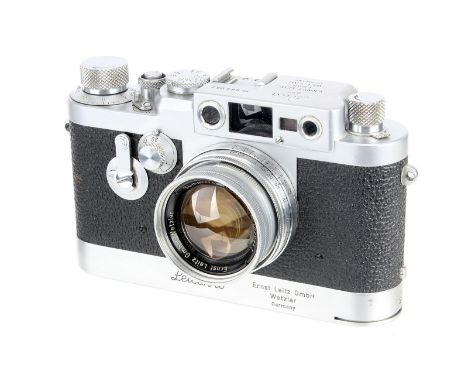 A Leica IIIg Rangefinder Camera, 1959, with Leicavit, chrome, serial no. 969052, with Leitz Summicron f/2 50mm lens, 1952, ra